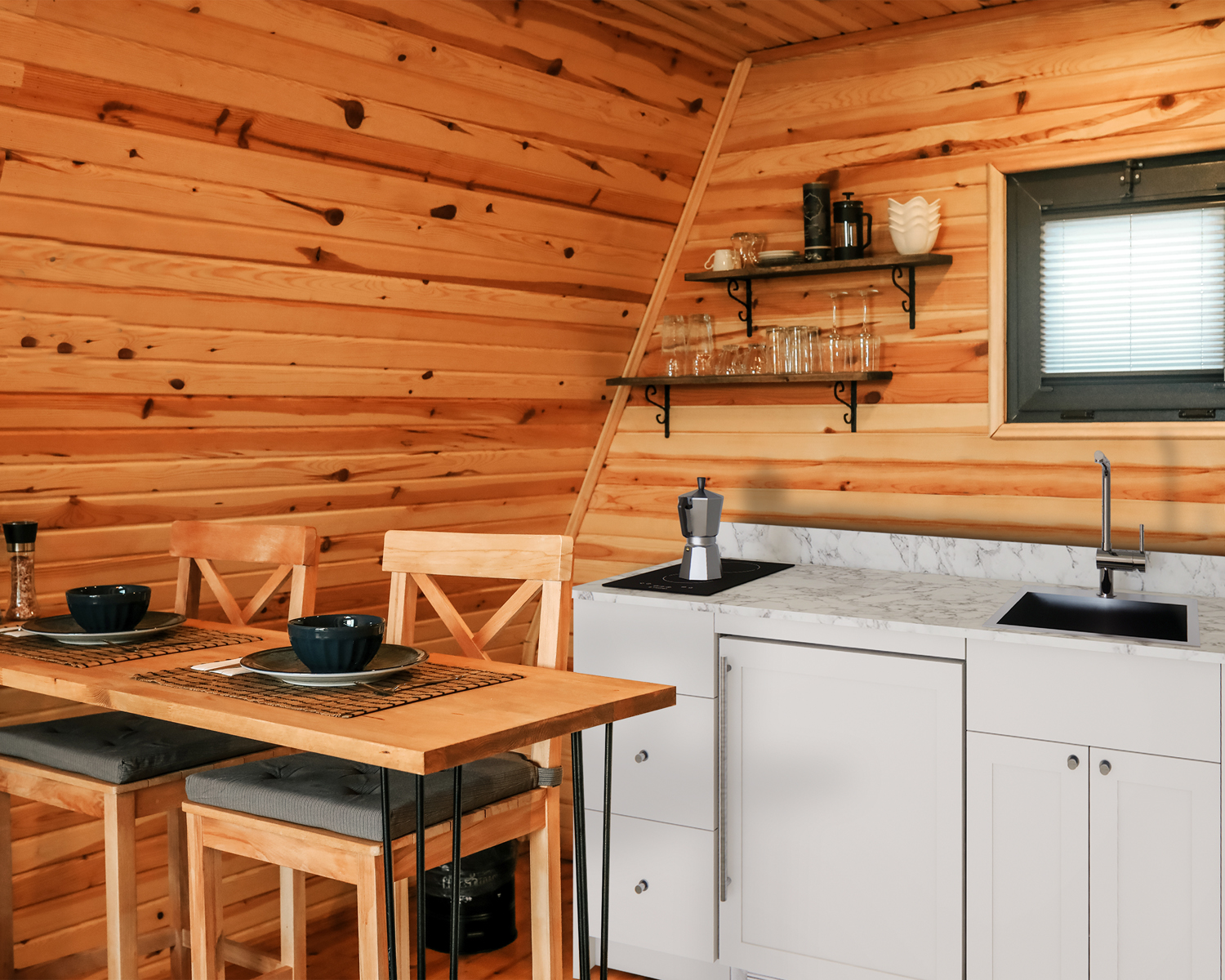 Turnkey Caldera Kitchen featuring pre-assembled cabinetry and countertop in white, complete with ENERGY STAR certified refrigerator-freezer, ENERGY STAR certified 115V induction cooktop, storage drawers, and sink with faucet; ships in two boxes on one pallet